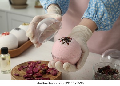 Woman In Gloves With Self Made Bath Bomb At White Table Indoors, Closeup