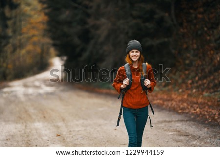 woman goes on the road with a backpack on the back tourism hiking                       