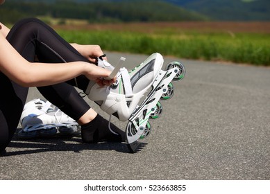 Woman Is Going Roller Skating. Putting On In-line Skates. Close Up. Sport Lifestyle.