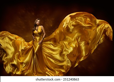 Woman Gold Dress, Lady In Fluttering Silk Gown, Fashion Beauty Model, Fabric Waving On Wind, Beautiful Girl With Long Dynamic Flying Cloth