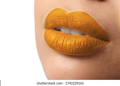 Woman with golden lipstick on white background, closeup