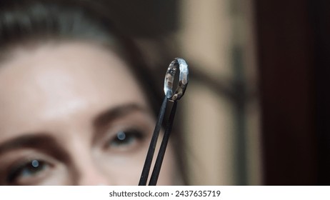 Woman goldsmith looking at crafted silver ring. Jewelry handicraft. Ring craft. Close up. High quality photo - Powered by Shutterstock