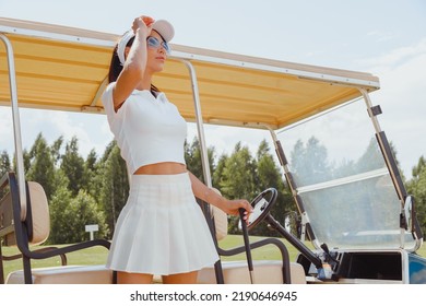 Woman golf car driver in white uniform, stand at club car