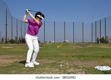 Woman At The Golf Driving Range