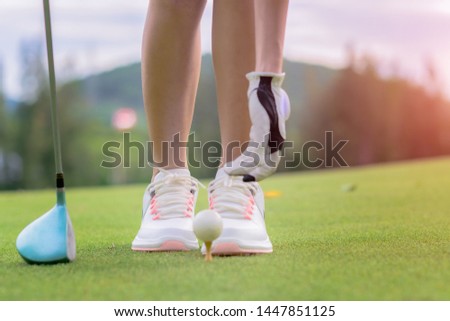 woman golf player prepare pin golf ball to the green, concentrate and ready to hit the ball away to the destination farway for winning in score rate