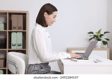 Woman with good posture working in office