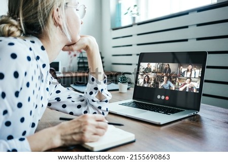 Woman with googles has video call conference with her remote team. Laptop with camera teamwork