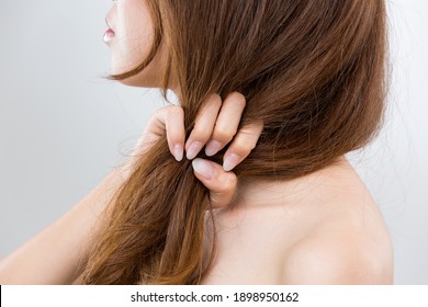 The Woman Is Grabbing Her Damaged Hair.