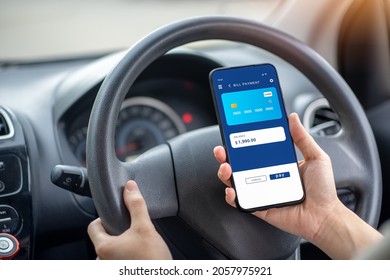 A Woman Grabs Her Mobile Phone And Opens A Mobile Banking App To Check Her Balance And Make A Credit Card Bill Payment. In A Black Car.