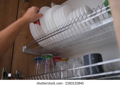 Woman Graceful Hand Takes Out Clean Plate From Cupboard