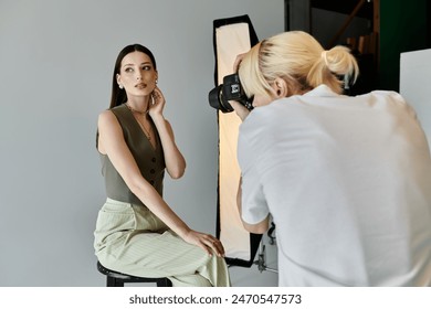 A woman gracefully sits on a stool in front of a photographer. - Powered by Shutterstock