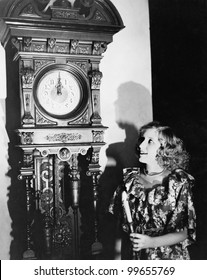 Woman With Grandfather Clock At Midnight