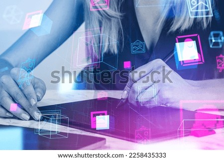 Woman graphic designer making NFT art products, stylus in hand. Virtual gallery hologram in metaverse. Concept of digital content creator