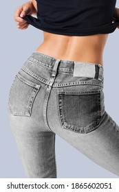 Woman In A Gray Jeans With A Tag Mockup