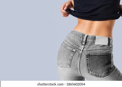 Woman In A Gray Jeans With A Tag Mockup