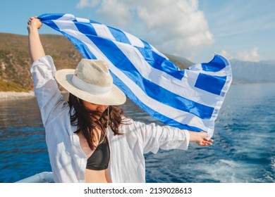 woman with greece flag at cruise boat lefkada island greece