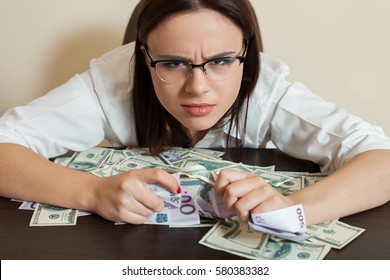 Woman With Greedy Person Hugs A Lot Of Money