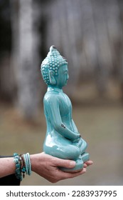 Woman with green Buddha statue in hands.  France.  - Shutterstock ID 2283937995