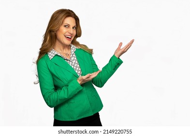 A Woman In A Green Business Suit Smiling And Pointing To Camera Right