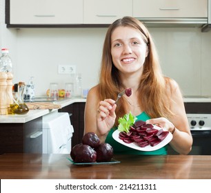 Woman In Green Eating Boiled Beets At Home Interior