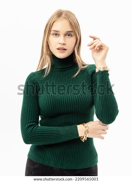 Woman in green knitted\
turtleneck on white background. Soft high collar. Vertical.\
Knitwear viscose noodles
