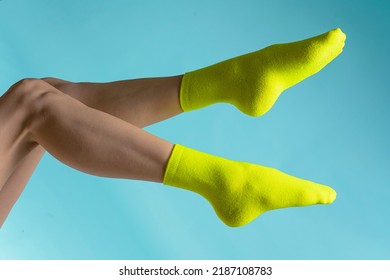 Woman With A Green Socks On Her Feet. Isolated On White Background