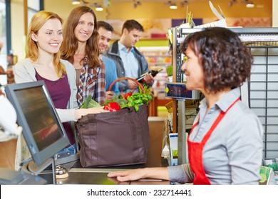 Woman With Groceries Waiting In Line At The Supermarket Checkout