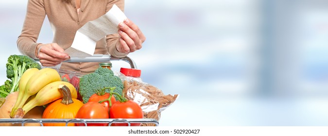 Woman With Grocery Receipt And Shopping Cart.