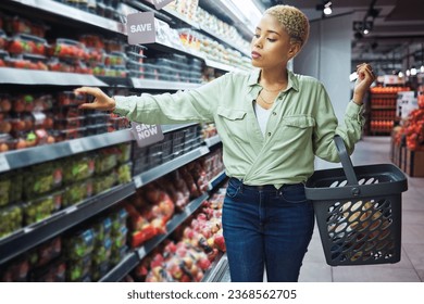 Woman, grocery shopping and fruits choice, discount and sale or wholesale promotion for healthy food and basket. African customer with strawberry package in retail, convenience store or supermarket - Powered by Shutterstock