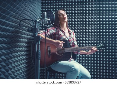 Woman With Guitar In Recording Studio