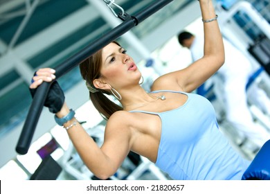 Woman At The Gym Exercising On A Machine