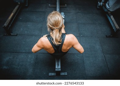 Woman at gym working out - Shutterstock ID 2276543133
