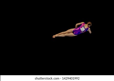 Woman Gymnast Flying In Air Somersault Exercise Gymnastics On Black Background