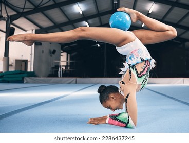 Woman, gymnastics and ball for flexible performance, body balance and dancer in sports arena. Female, rhythmic movement and dancing upside down for creative talent, solo concert and agility challenge - Powered by Shutterstock