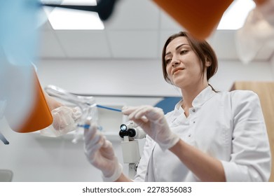 Woman gynecologist taking sample of biomaterial from patient urogenital tract - Shutterstock ID 2278356083