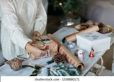 woman hads wrapping christmas presents