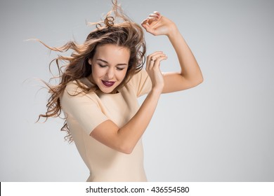 The Woman With Hair Blowing In The Wind On Gray