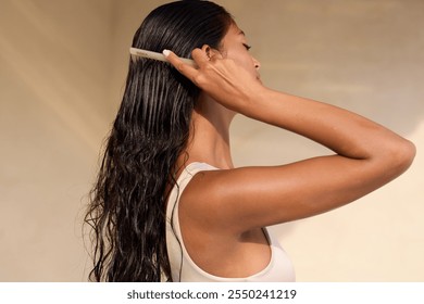 Woman Hair Care Routine: A serene setting showcasing a woman with wet hair being gently brushed. Emphasizing relaxation, beauty, and self-care in a minimalist, sunlit environment. - Powered by Shutterstock