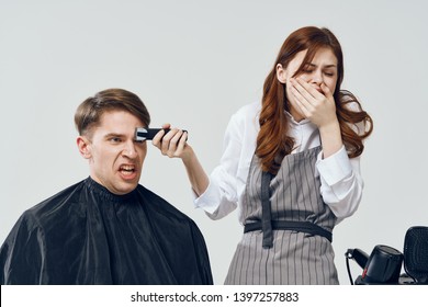 woman hairdresser with a clipper next to a man barbershop gray background - Shutterstock ID 1397257883
