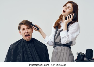 Woman Hairdresser Does A Haircut To A Man And Talks On The Phone