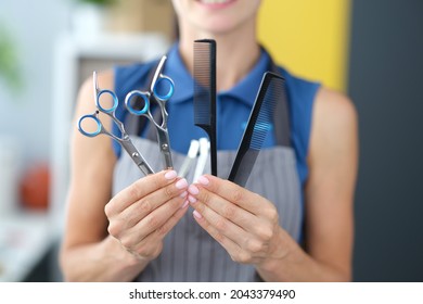 Woman Hairdresser Holding Combs And Scissors For Hair Cutting Closeup