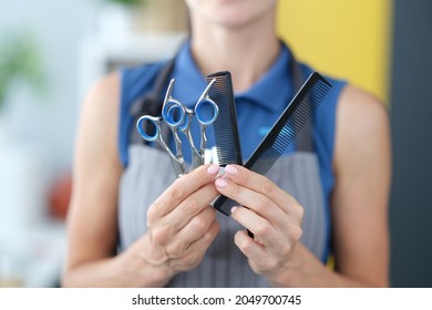 Woman Hairdresser Holding Hair Scissors And Comb In Hands Closeup