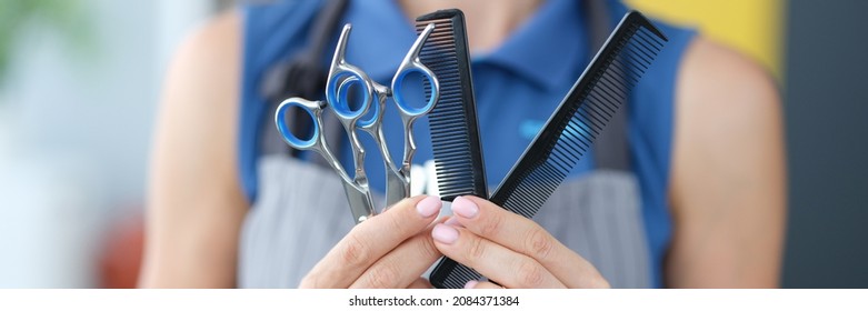 Woman Hairdresser Holding Hair Scissors And Comb In Hands Closeup