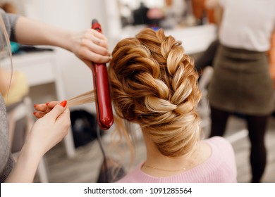 Woman hairdresser making hairstyle to blonde girl in beauty salon. - Shutterstock ID 1091285564