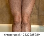 Woman with hairy legs in the shower