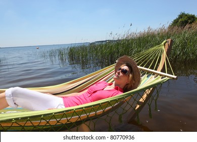 Woman In Hammock By Lake