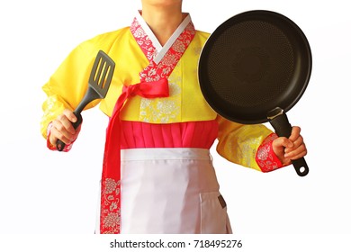 The Woman In The Hanbok Korean Traditional Dress Is Holding A Cooking Tool. Holiday Stress Concepts. 
