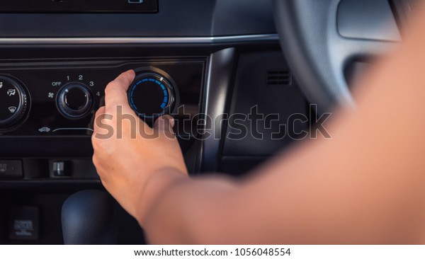 Woman Hand is Adjusting Eco Mode Button for Air\
Conditioning in Vehicle Car, Close-Up of Female Hand Reduce Air\
Flowing for Ecology Saving Energy Function for Personal Transport.\
Power Save Concept