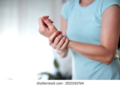 Woman With Hand And Arm Pain At Home.