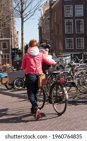 Woman With Hand Bike Transporting Her Child In The City Of Amsterdam